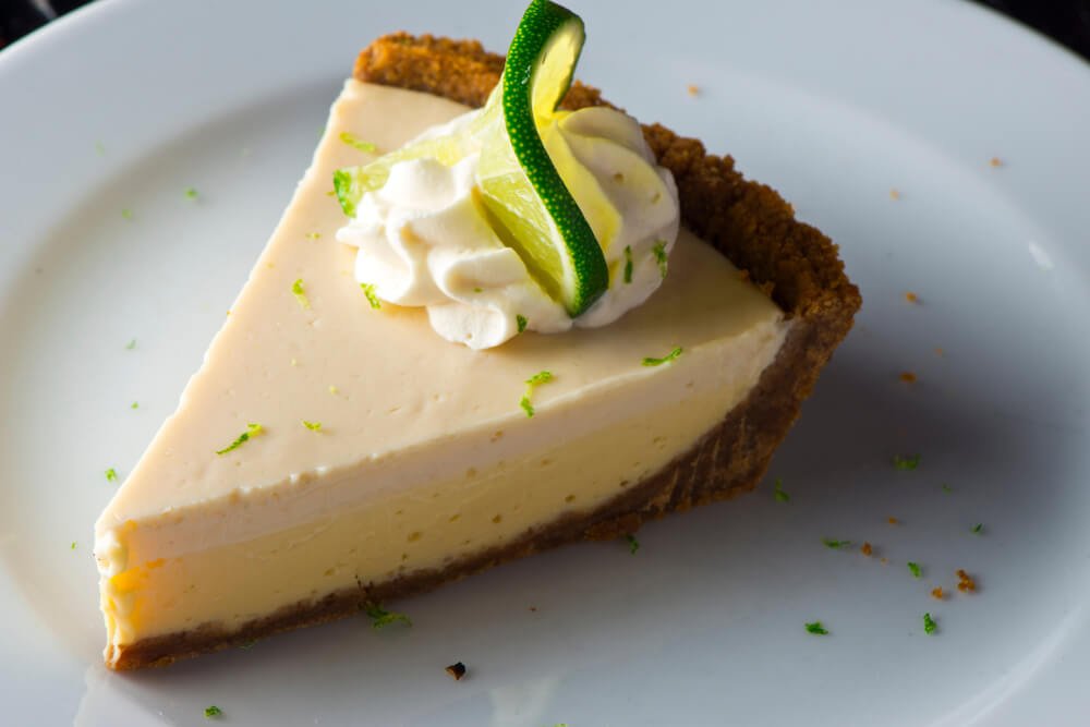 a slice of key lime pie covered in lime zest