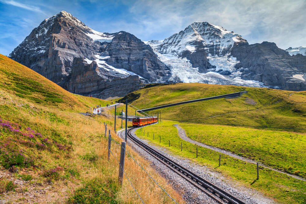 Famous electric red tourist train coming down from the Jungfraujoch station (The Top of Europe) in Kleine Scheidegg.