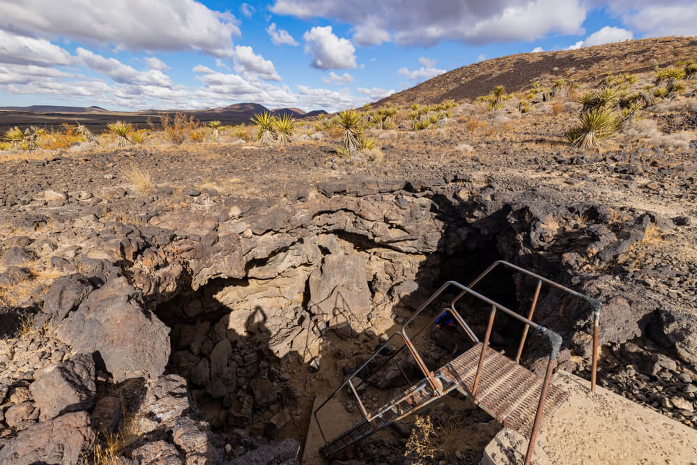 rickety staircase leading down into the lava tube on this mojave national preserve hike