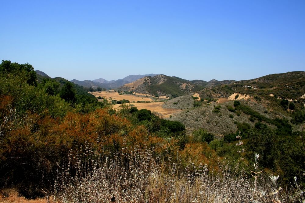 Panoramic view of meadows, hills and sky in Malibu Creek State Park, California