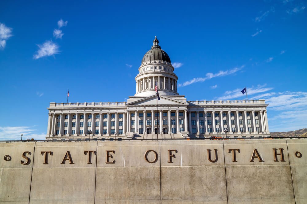 state capitol building on a sunny day in slc with the words "STATE OF UTAH" written in front of the building