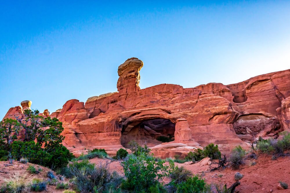 the red rocks of tower arch in a more remote park of arches national park, seen shortly after sunrise in the morning light