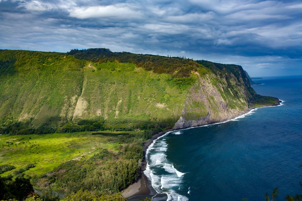 an aerial photo of the beautiful and lushly green waipio valley