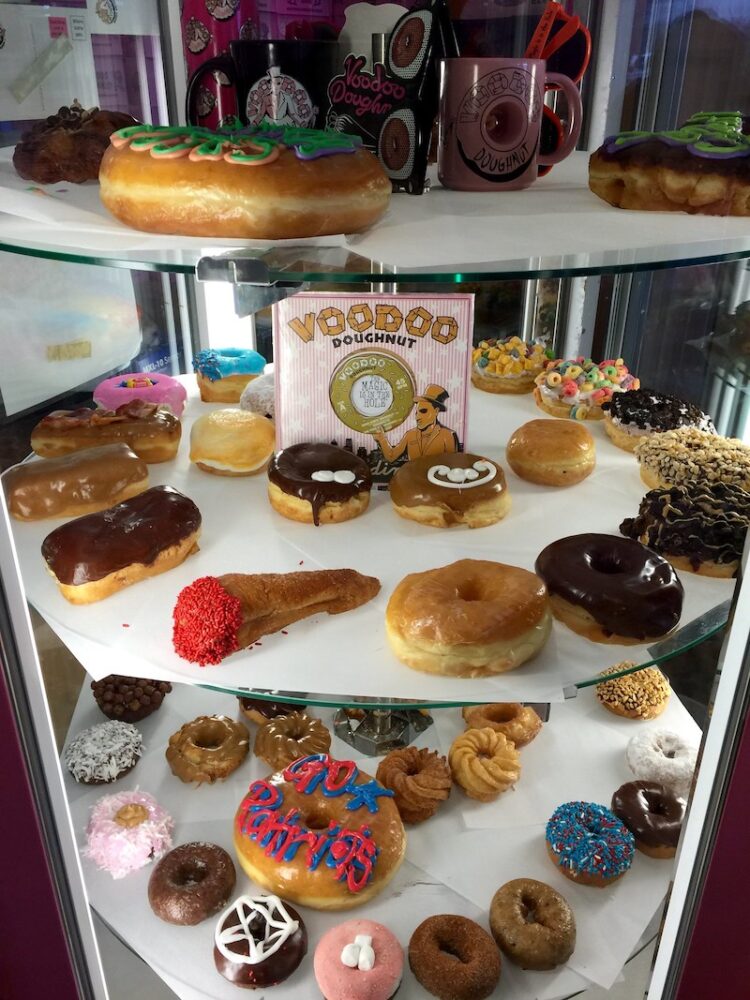 Tiers of many different kinds of colorful donuts at Voodoo Doughnuts