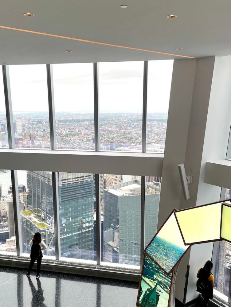 View from the window of One World Trade with people looking out at the city views