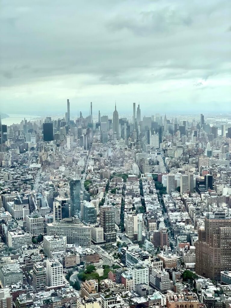 View of Uptown Manhattan as seen from One World Observatory on a partly cloudy day