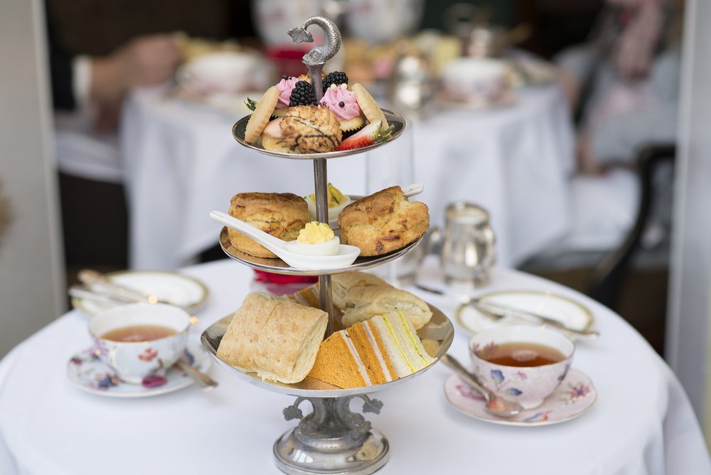 afternoon tea with a tiered tea cake stand and tea cups