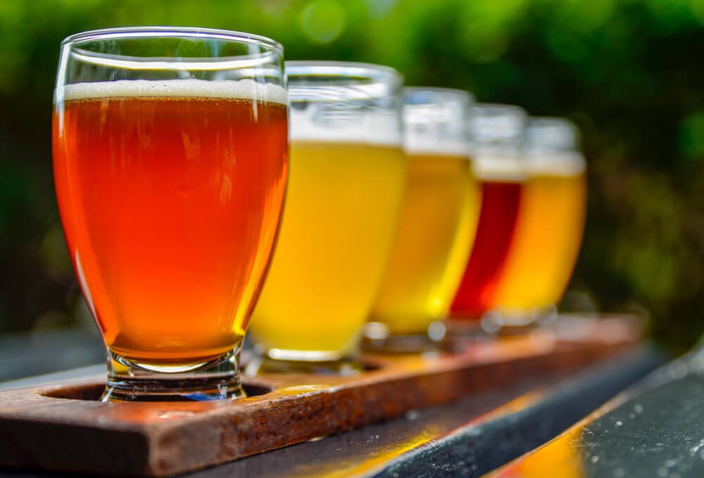 A flight of five colorful ciders