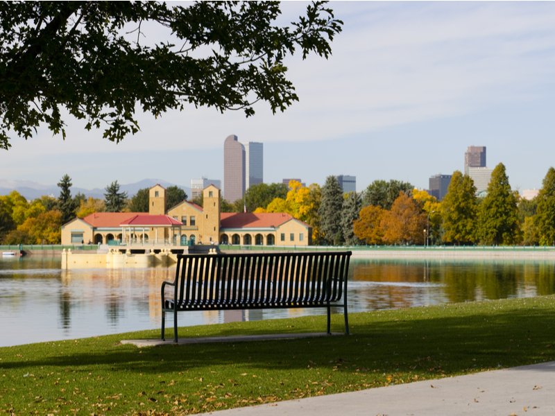 Bench looking over the lake and pretty structures downtown in Denver