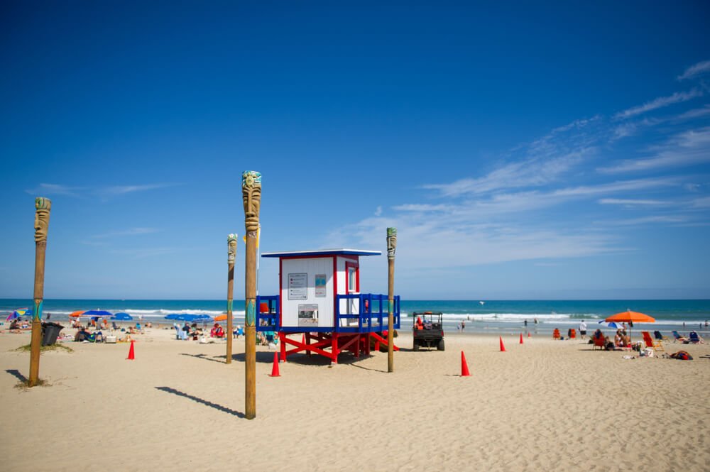 Red white and blue lifeguard stand on the beach in cocoa beach florida
