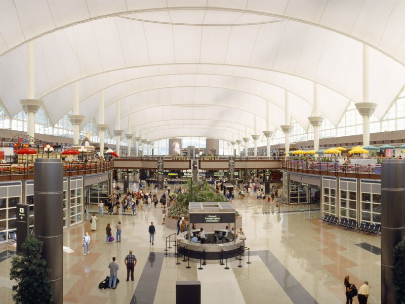 Denver International Airport - view of food courts and people walking around the airport interior