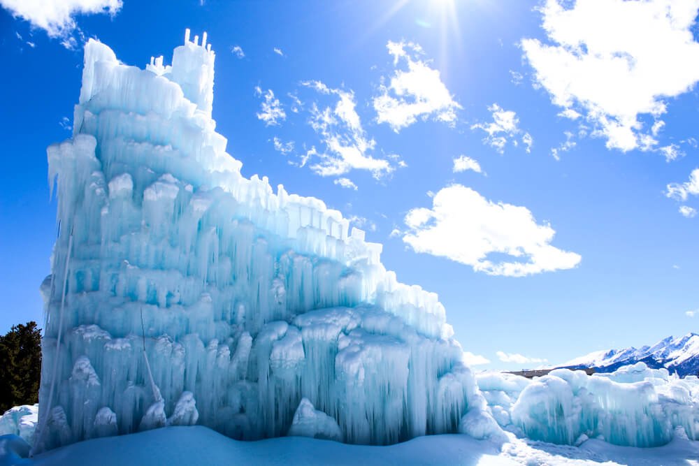 Magical ice castle made entirely of water and ice and snow in the sun on a winter day in Colorado