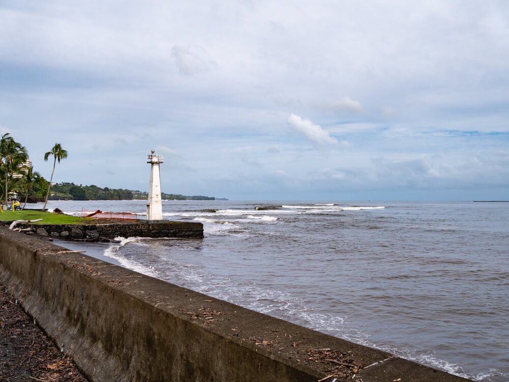 white lighthouse on a cloudy day at a famous place in hilo