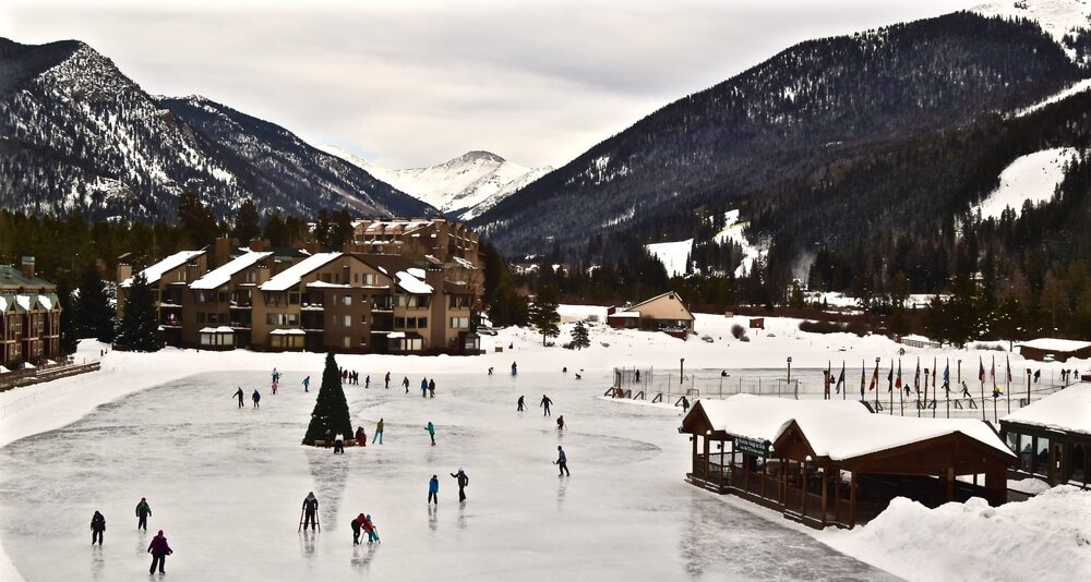 people ice skating at the keystone ski resort in colorado, a popular day trip from denver in winter