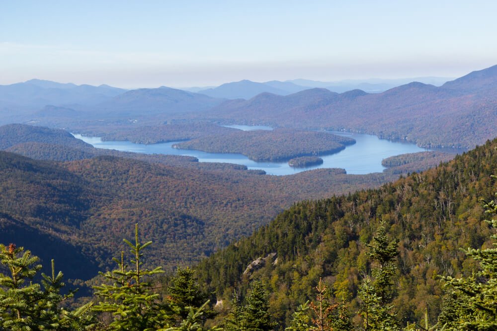 view from whiteface mountain over the mountains and waters of the lake placid