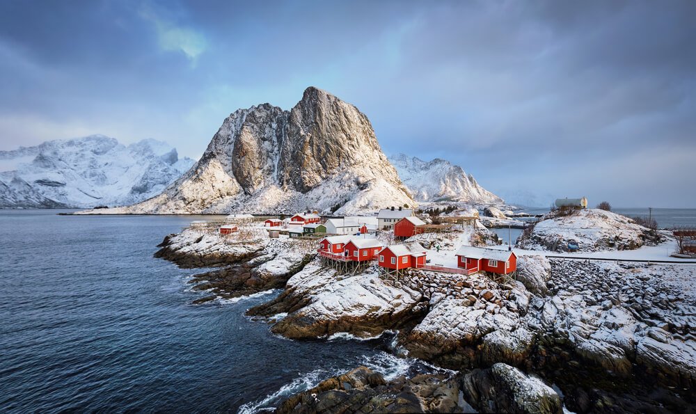 red fishing buildings on rocky islands in norway