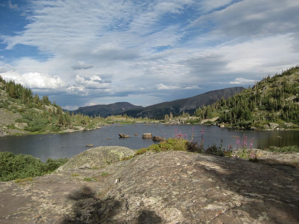 Mohawk Lake is surrounded by lichen covered rocks. It is a popular hiking trail in Breckenridge Colorado