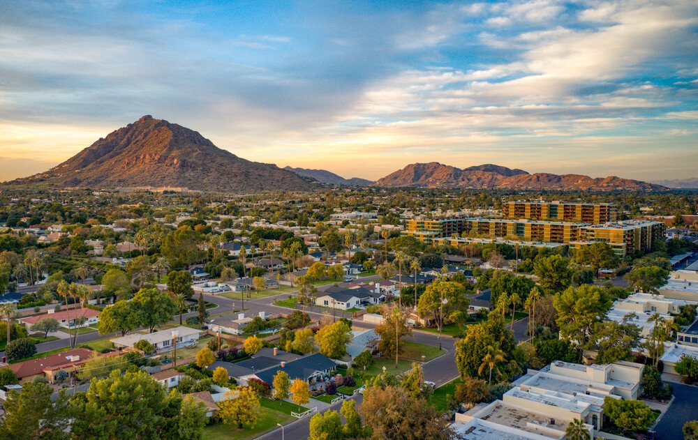 The city of Scottsdale Arizona at sunset with a small mountain peak in the distance