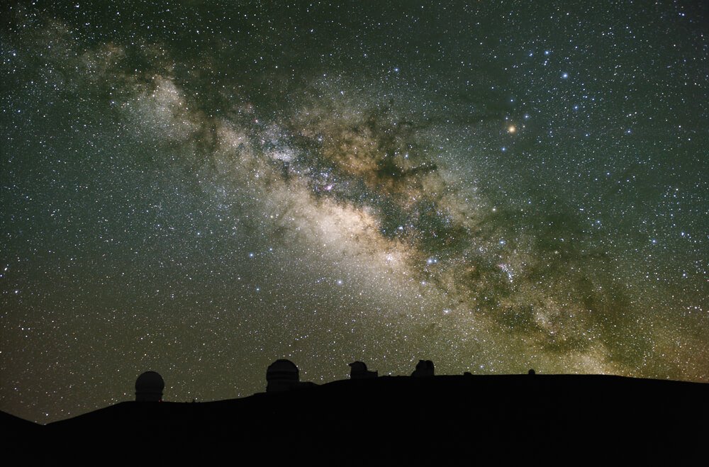 the stars of the milky way galaxy visible over the telescopes on mauna kea 