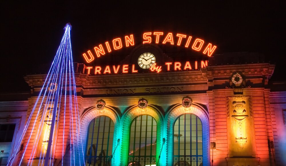 front of union station in Denver at christmas, colorful rainbow lights and christmas tree