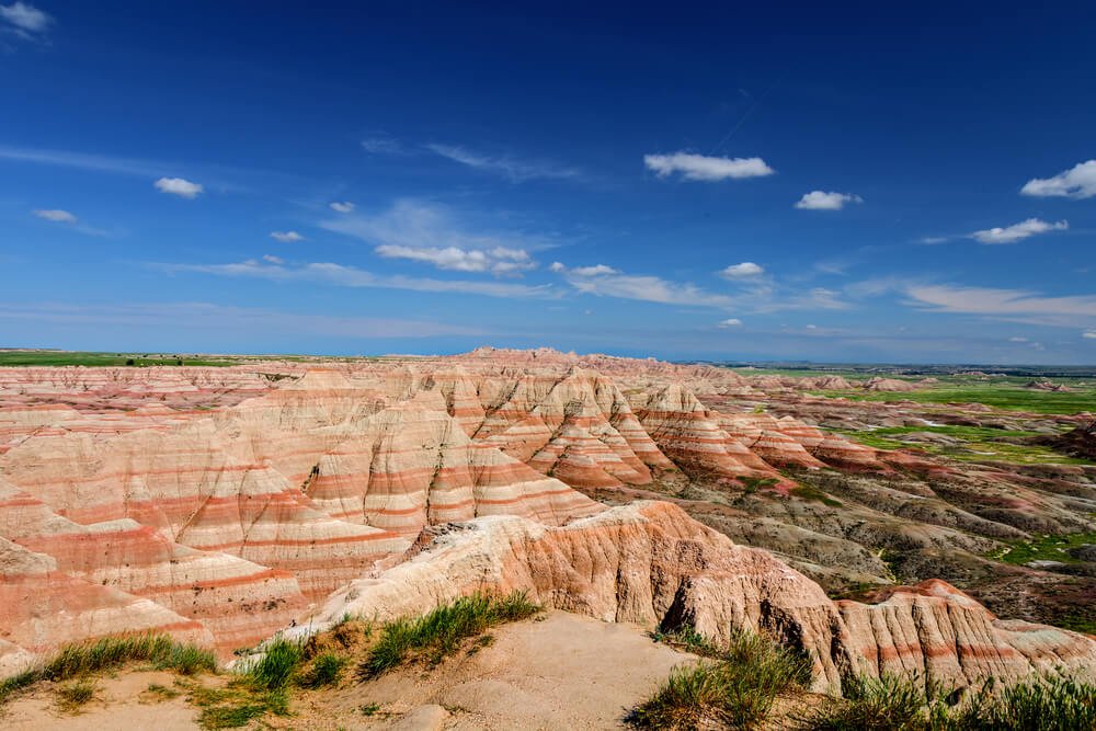 Striated red and tan rock and grasslands in the Badlands of South Dakota