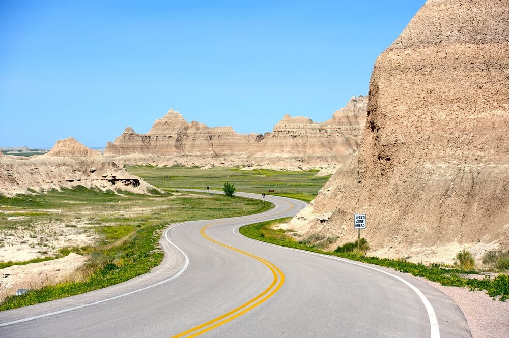 Driving the badlands loop road, winding street on a sunny day in South Dakota road tripping