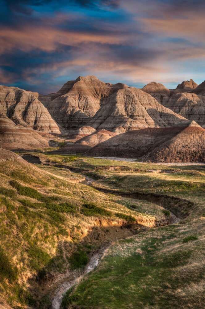 Small hills in the Badlands National Park at sunset with light falling on the rock formations