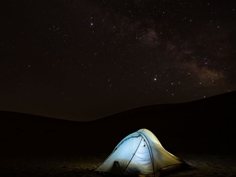 Camping in sand dunes in Colroado with stars overhead