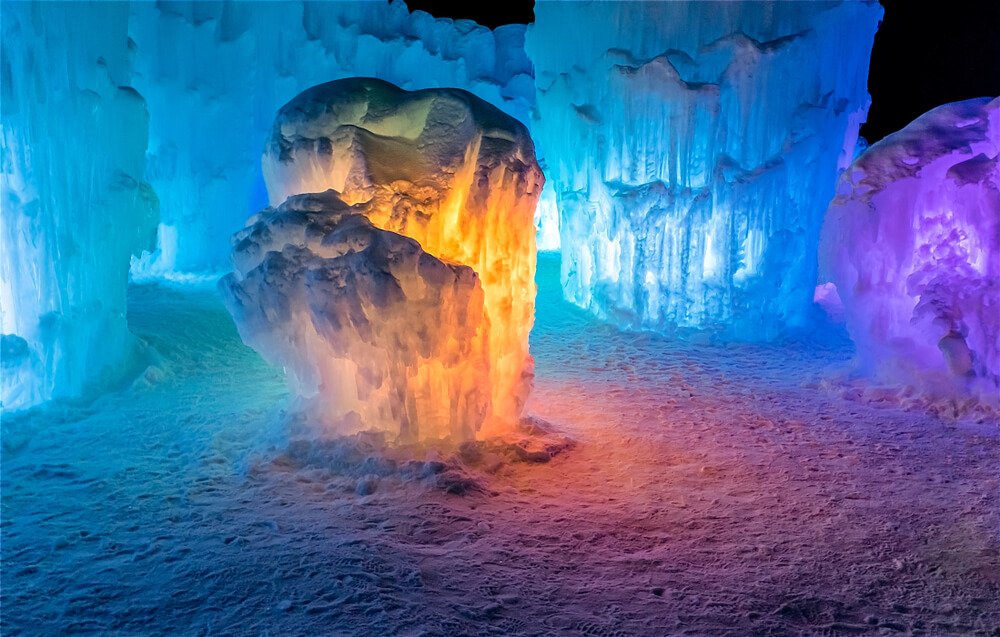 One room of the Dillon ice castle with blue, orange, and purple lighting creating a unique ambiance