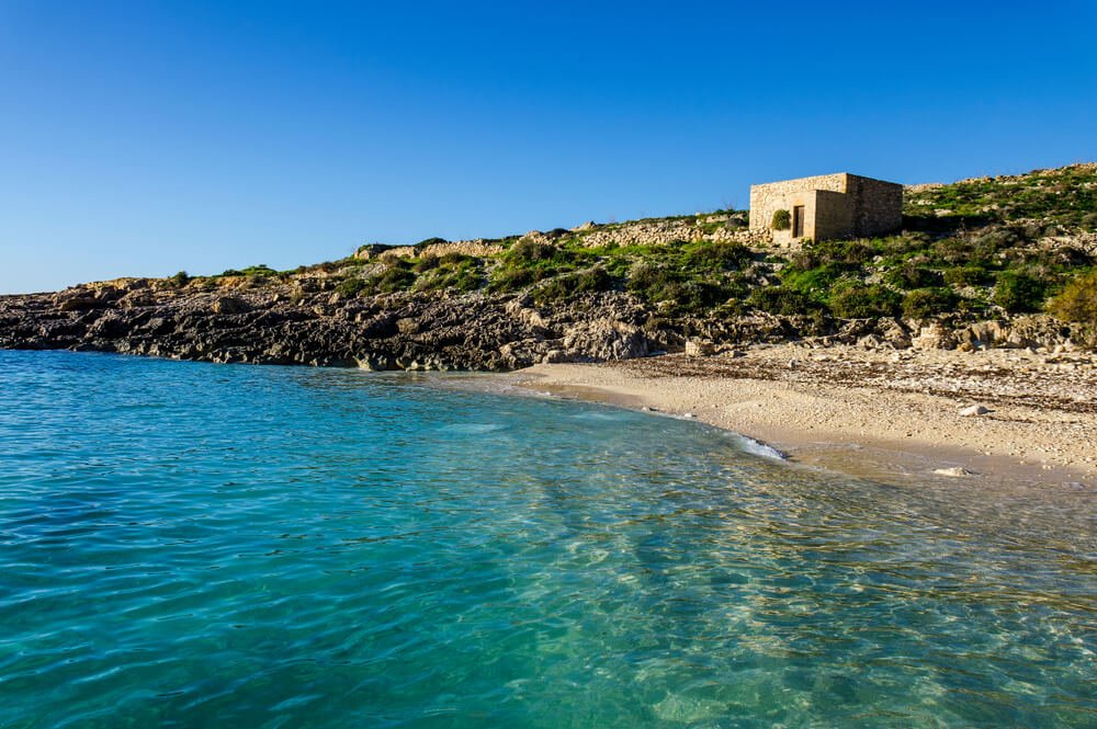 The clear turquoise waters at the pebble beach in Hondoq ir Rummien, Gozo
