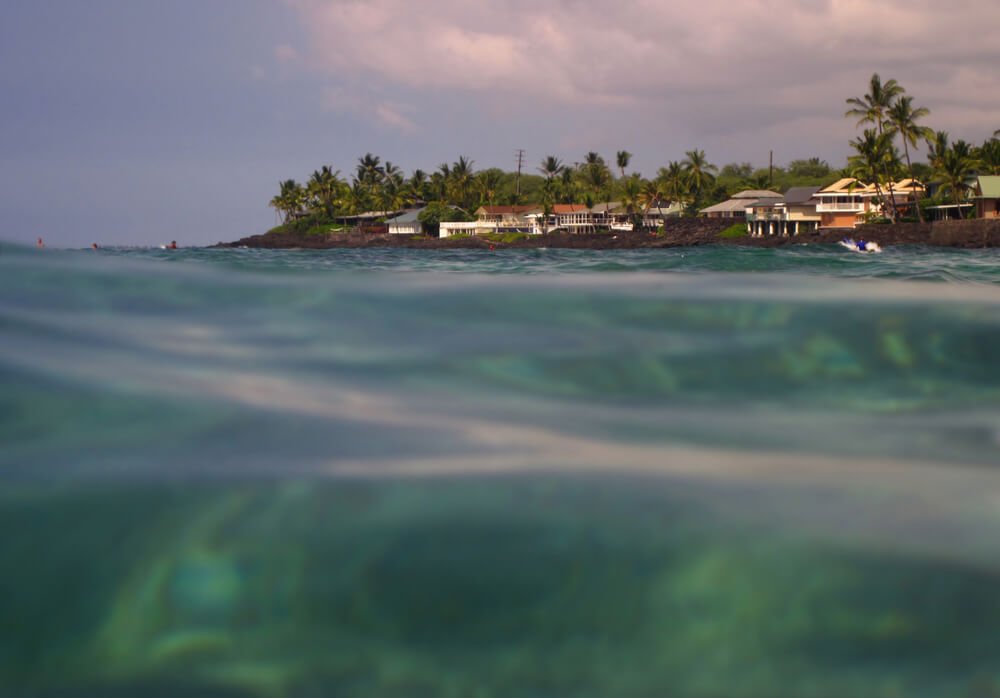 view seen from half under the water half above the water near the beach in kona