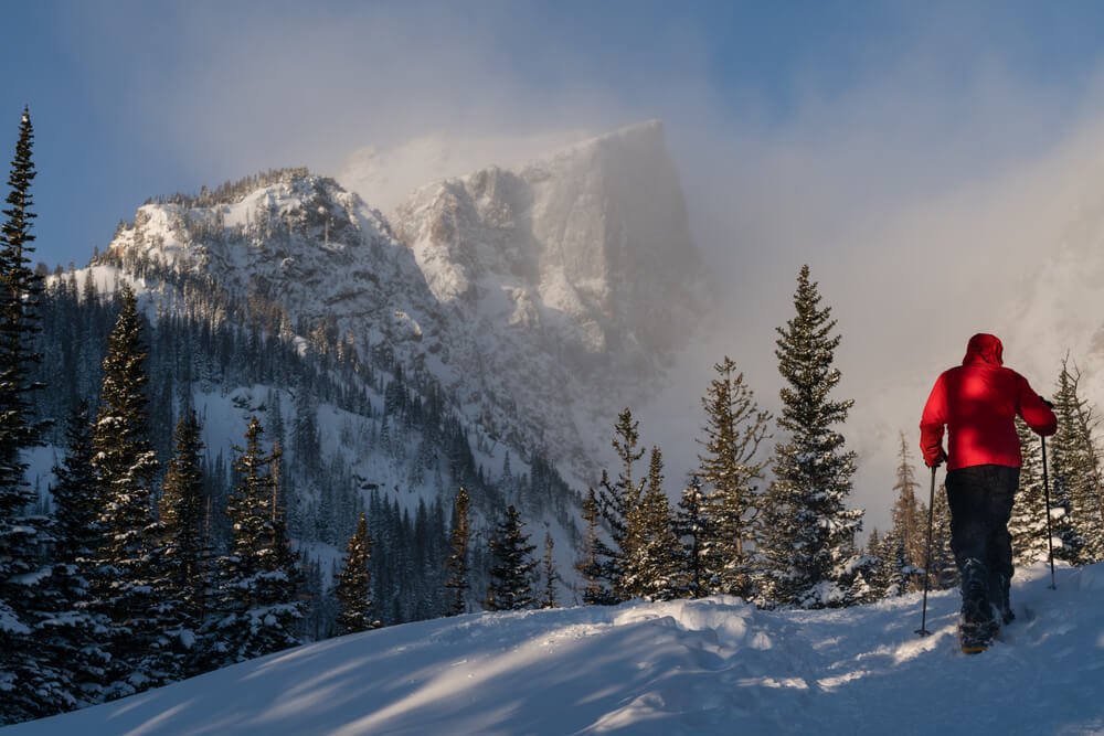 person snowshoeing in rocky mountain national park