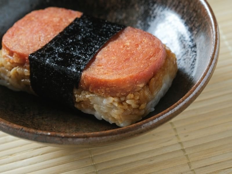a piece of spam musubi in a plate