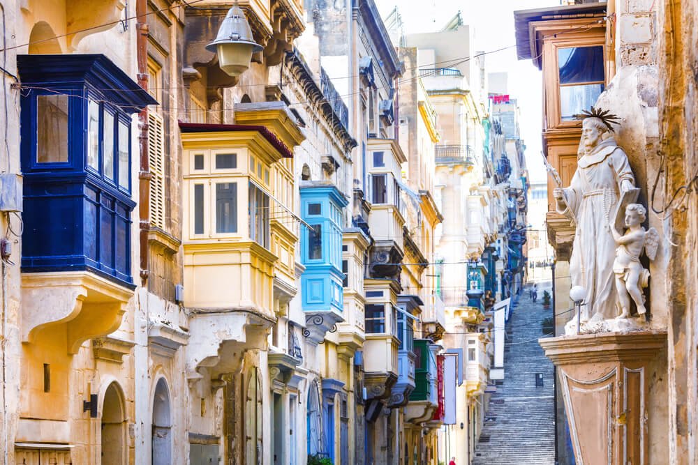 Typical narrow streets with colorful balconies in Valletta , Malta
