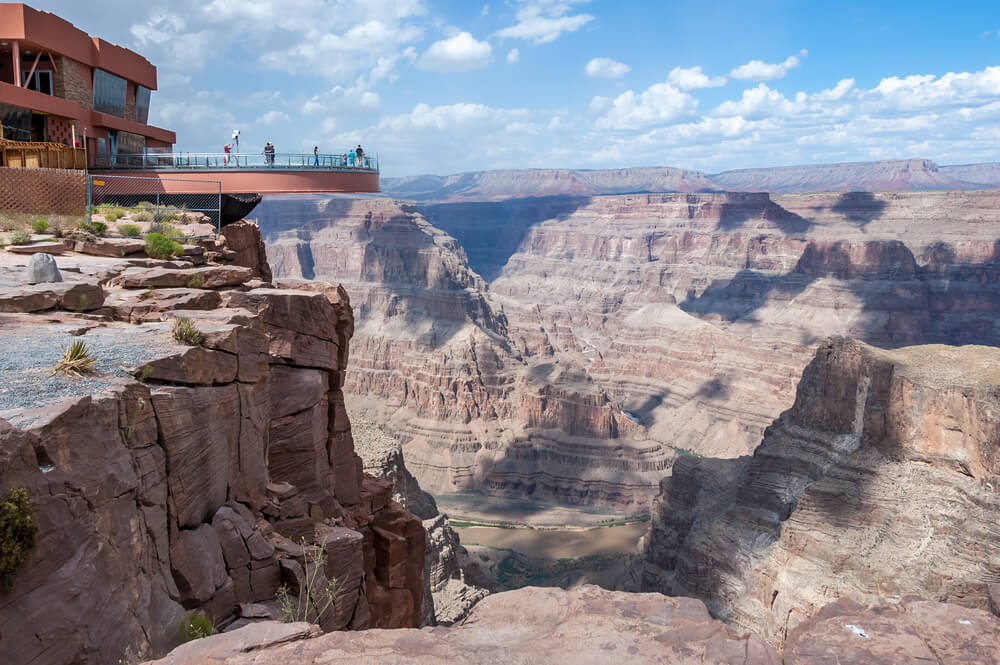 a skywalk deck at the grand canyon west rim, looking over canyon views below