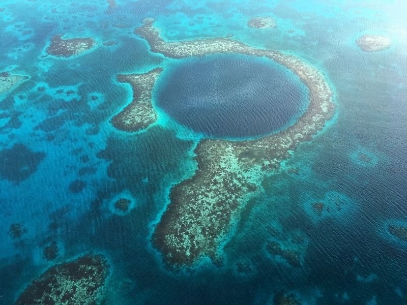 The blue hole in belize, as seen from above, a sinkhole surrounded by a reef