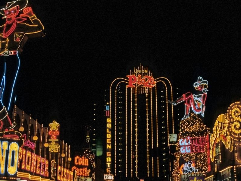 the downtown area of fremont street all lit up with neon signage