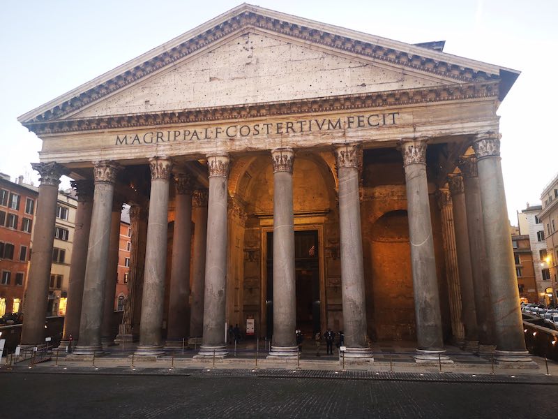Famous Pantheon building with lots of columns and latin writing on the front