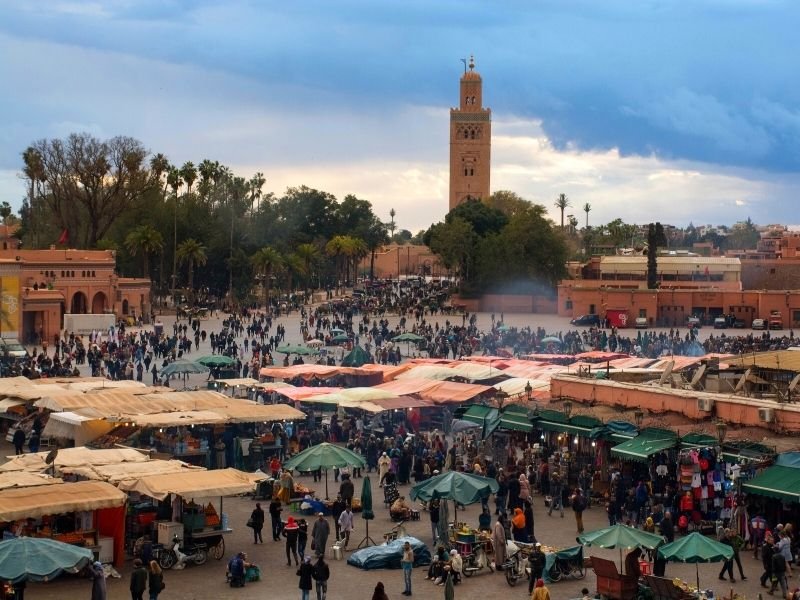lots of people visiting jemma el fna, the main marketplace in marrakech