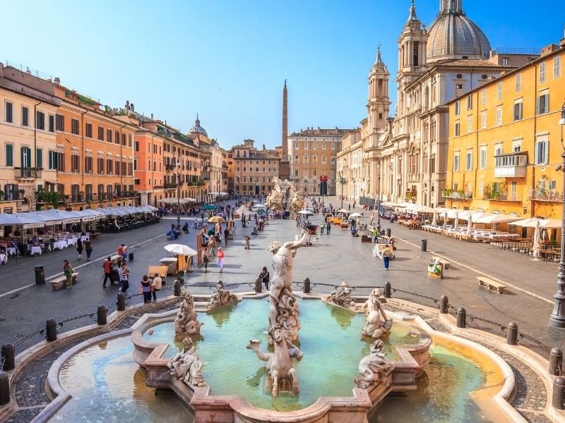The scenic Piazza Navona in Rome, Italy with plenty of people enjoying the scenery