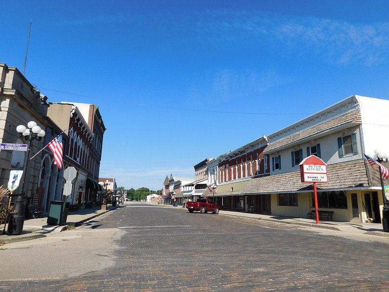 the downtown of arcola illinois with views of a mostly empty peaceful street