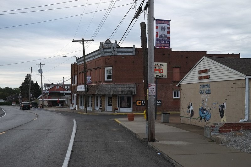 a street corner in the town of chester illinois with street art and old buildings