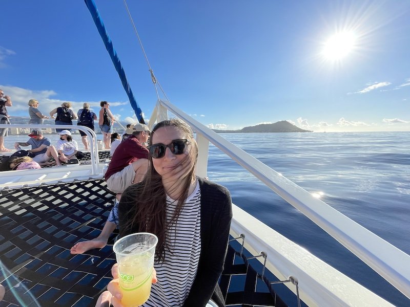 Allison on the catamaran nets with a glass of pineapple juice