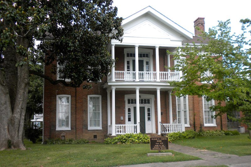 a fancy house with brick and white pillars in metropolis illinois