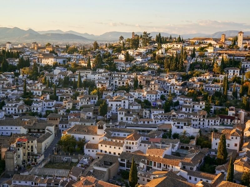 view of the historic white houses of granada from above with the traditional roofs