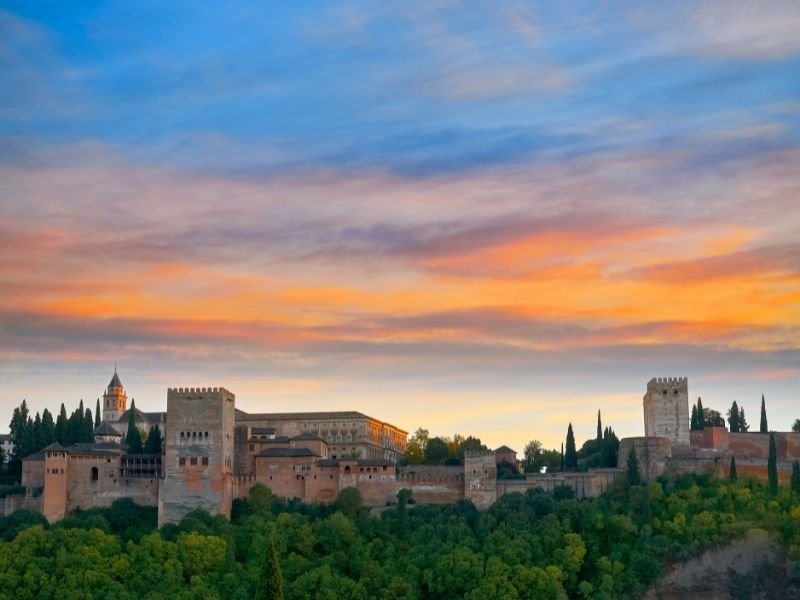 sunset over the alhambra as seen from the mirador de san nicolas