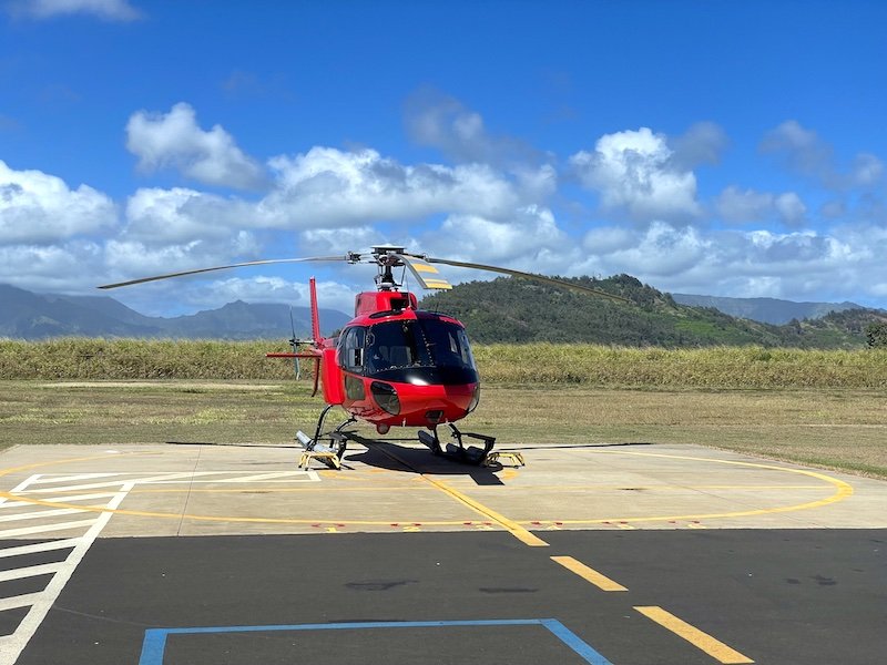 Red helicopter on the helipads in Lihue Airport