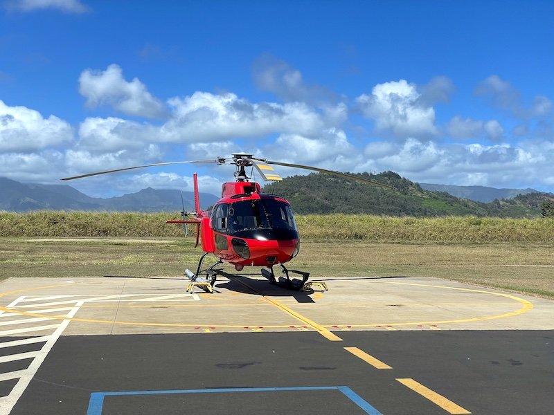 Red helicopter on the helipads in Lihue Airport 