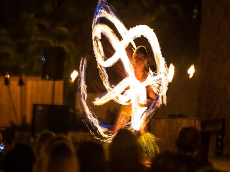 person dancing with fire at a luau