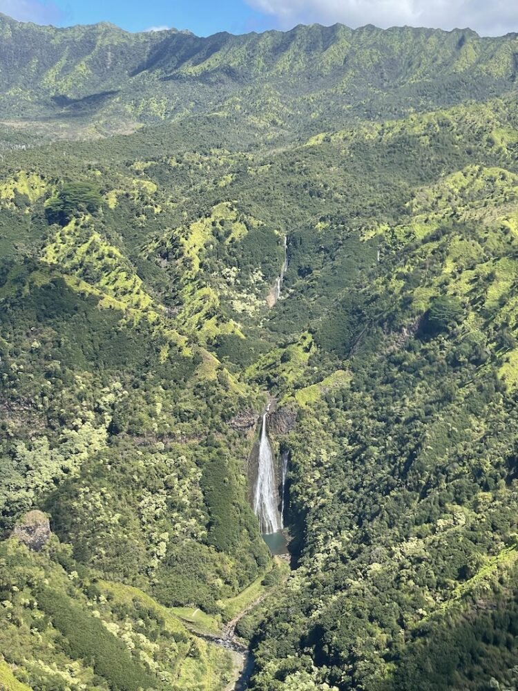 The famous Jurassic Falls, a 400 foot waterfall as only visible from the sky on a doors off helicopter tour in Kauai